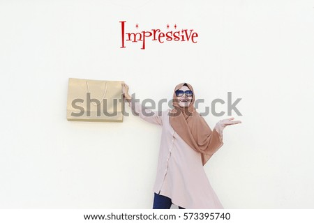 Impressive : The Magic Marketing and Positive Thinking Words seller should use, over the Malaysian lady holding a Gold Paper Bag with authentatic smile and isolated white background.