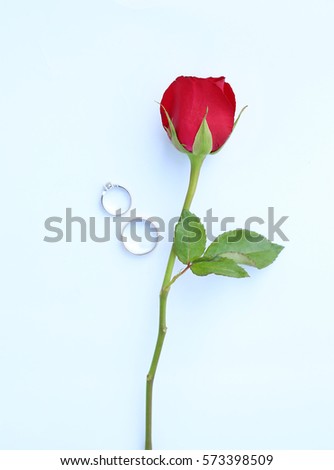 Red roses flower with wedding ring on white background.