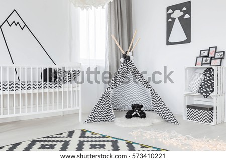 Black and white child room with a cot