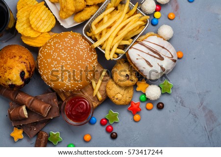 Assortment of unhealthy products that's bad for figure, skin, heart and teeth. Fast carbohydrates food. Space for text Royalty-Free Stock Photo #573417244