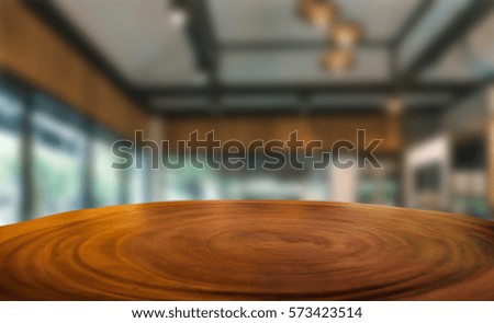 Empty wooden desk over blurred cafe