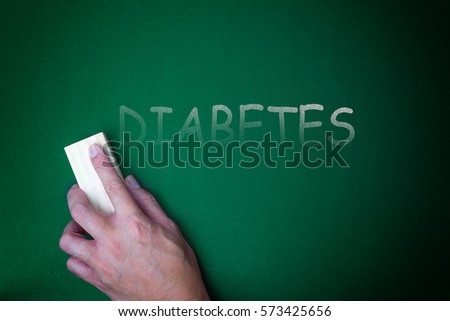 hand holding eraser on text diabetes on a chalkboard.