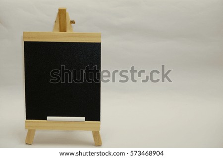 Wooden mini blackboard with white chalk isolated on white background