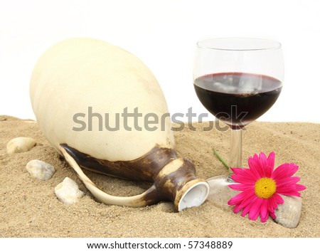 Still life with a clay bottle and wineglass on sand