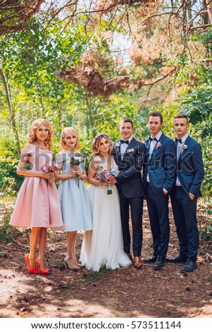 beautiful newlyweds with their friends having fun together. Friendship picture. Bridesmaids and groomsmen with bride and groom.
