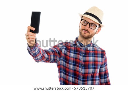 Studio shot of young man taking selfie picture with mobile phone
