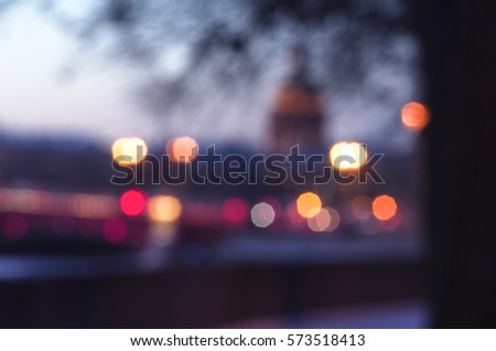 Unfocused cityscape of the embankment of river Neva and Saint Isaac's Cathedral on the back, light beams, winter morning, Saint-Petersburg, Russia Royalty-Free Stock Photo #573518413