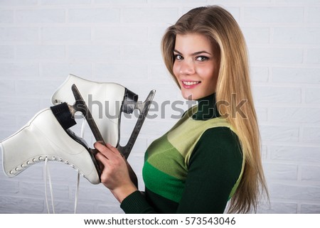 Young woman showing ice skates for winter ice skating sport activity