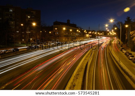Rays of lights, car lights on a road, at night Royalty-Free Stock Photo #573545281