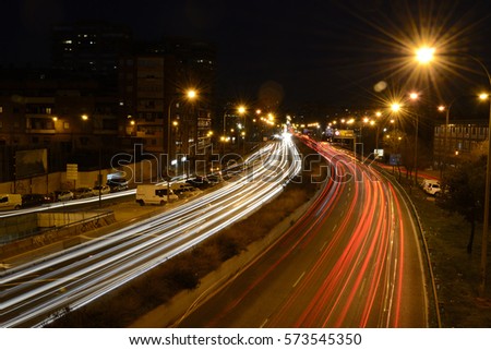 Rays of lights, car lights on a road, at night Royalty-Free Stock Photo #573545350