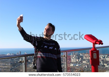a guy take a selfie on copy panorama background