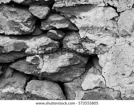 Fragment of vintage stone wall. Abstract background. Black and white photo.