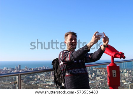 a smile  guy take a selfie on copy panorama background