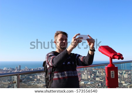 a  man take a selfie on  city panorama background batumi georgia