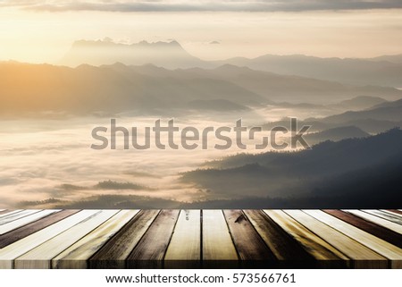 Empty wooden table with blurred sea mist and mountain background. Product display template
