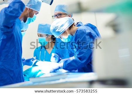 Close up of surgery team operating  Royalty-Free Stock Photo #573583255