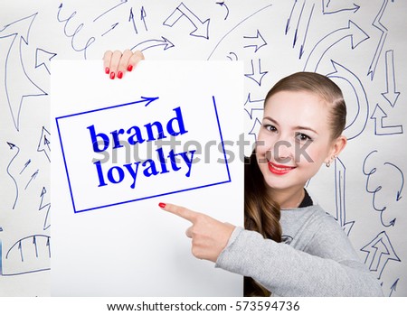 Young woman holding whiteboard with writing word: brand loyalty. Technology, internet, business and marketing.