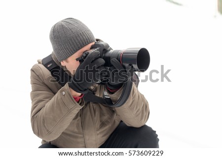 photographer taking pictures in the forest in winter.