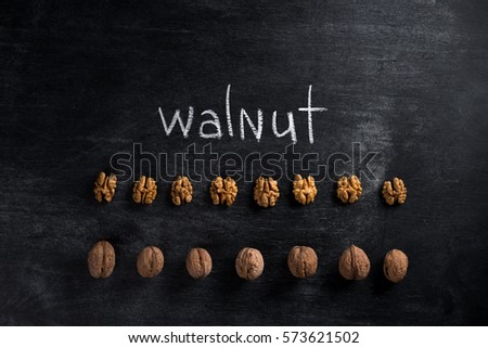 Top view picture of walnut over dark chalkboard background