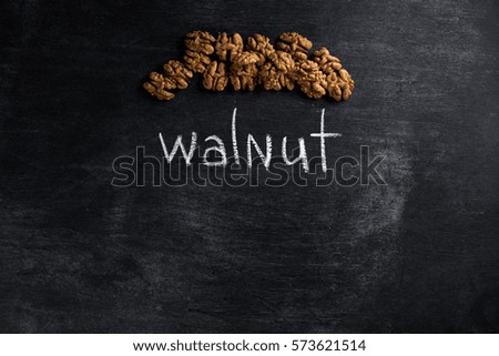 Top view picture of walnut over dark chalkboard background