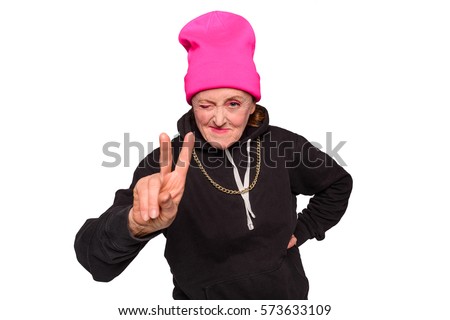 Grandmama throws a peace sign. Old woman has a style beyond her years and pulls a classic rapper pose. Horizontal photo of old gangsta mama, isolated on white.