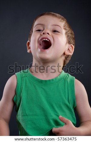picture of a very happy two years old kid over dark background