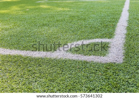 White stripe on the green soccer field.Detailed green soccer field grass lawn texture.