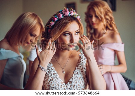 Wedding. Bridesmaid preparing bride for the wedding day. Bridesmaid helps fasten a wedding dress the bride before the ceremony. Luxury bridal dress close up. Best wedding morning. concept