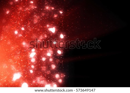 Red  abstract festive background, glitter or bokeh lights. Round defocused particles. isolated on black.