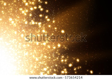 Golden abstract sparkles or glitter lights. Festive gold background. Defocused circles bokeh or particles. Template for design.