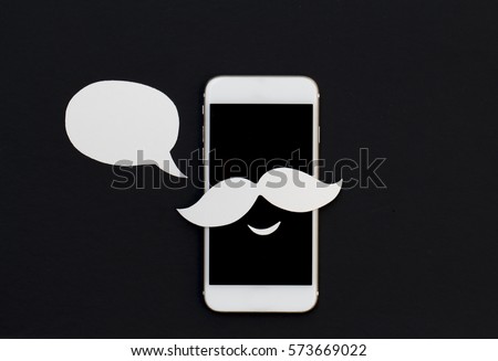 White phone with cartoon text bubble and smile. Smartphone in mustache paper cut collage with speech bubble. Creative cellphone banner template with text place. Smiling Iphone in hipster style photo