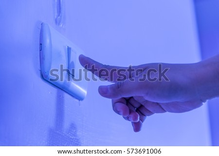 Pushing switch for open light on night,Dark Royalty-Free Stock Photo #573691006