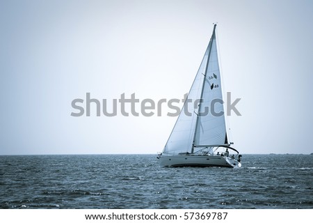 blue tone picture of yacht sailing on the sea