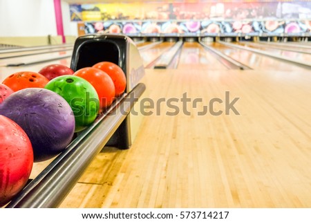 Bowling equipment. Close up of bowling shoes and lilac ball lying on bowling alley