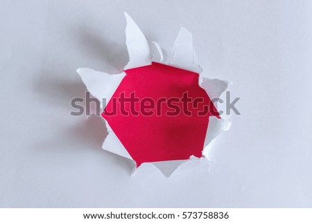 Torn paper with red background.