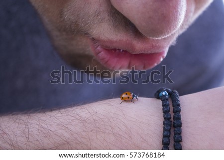 Kissing a ladybug.