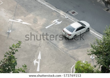 White arrows sign and car on road