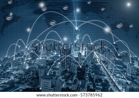 Network connection line between building over the top view of Bangkok Cityscape at night, Mahanakhon and world map background which dicut each elements, cool tone color, network and connection concept