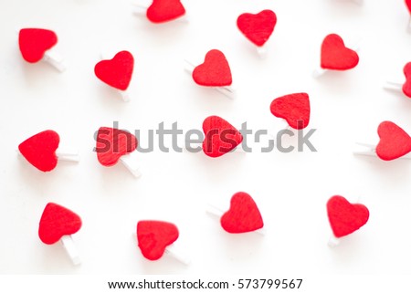 Valentine background with red hearts row border on clothespins on white rustic  background . Happy lovers day
