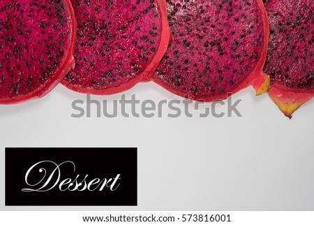 Close up a slice of dragon fruits with a word DESSERT on a isolate white background. A healthy and diet conceptual.