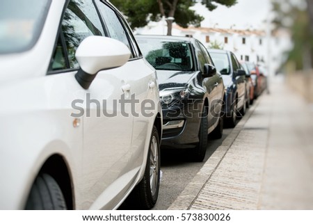 Cars parked along the street. Royalty-Free Stock Photo #573830026