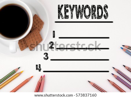 Keywords blank list. White desk with a pencil and a cup of coffee.