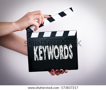Keywords. Female hands holding movie clapper 