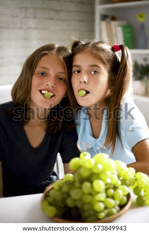 happy couple eating fresh grapes