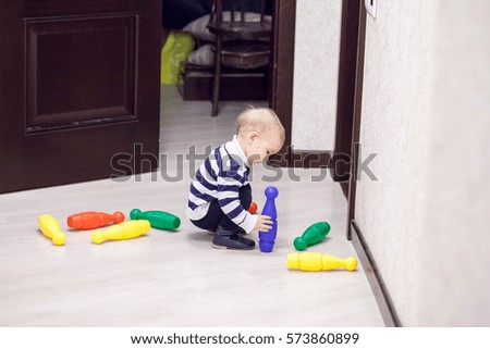 A little boy, a child playing with colorful toys-pin bowling