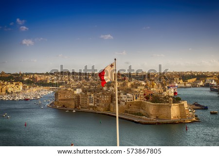 Maltese flag and Fort St Angelo dominates Grand Harbour of Valletta, Malta Royalty-Free Stock Photo #573867805