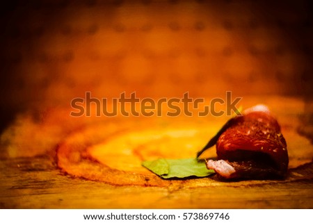grunge, vintage, vignetting. a piece of meat in spices with bay leaf,copy space.