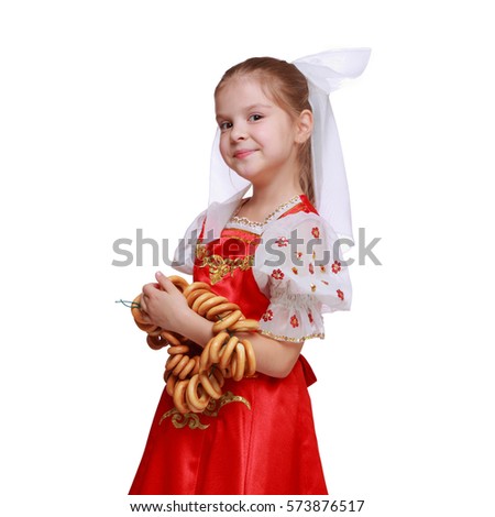 Portrait of pretty young russian girl wearing traditional costume and holding round cracknel/Lovely russian young girl with traditional russian food isolated over white background
