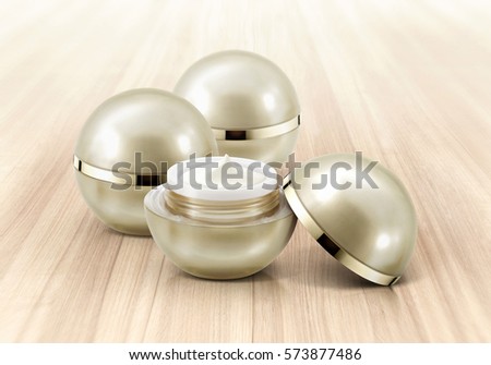 Golden sphere cosmetic jar on wood background