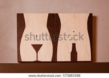 man and woman wooden abstract sign